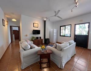 a living room with two white couches and a table at Padre Aviles in Olías