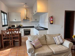 a living room with a couch and a kitchen at Padre Aviles in Olías