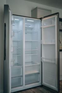 a white refrigerator with its doors open in a kitchen at Wiske House in Stockton-on-Tees