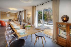 a dining room with a long wooden table and chairs at Chalet Ysopi - OVO Network in Saint-Jean-de-Sixt