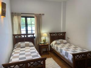 a bedroom with two beds and a window at Padre Aviles in Olías