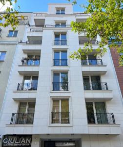 a tall white building with balconies on it at Paris luxury top centre Apt with office space in Sofia