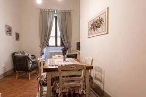 d'une salle à manger avec une table, des chaises et une fenêtre. dans l'établissement Toscanella Romantic, à Florence