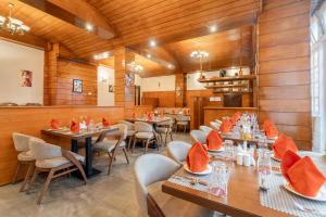 a restaurant with wooden walls and tables and chairs at Summit Alpine Abode Hotel Centrally Air Conditioned in Gangtok