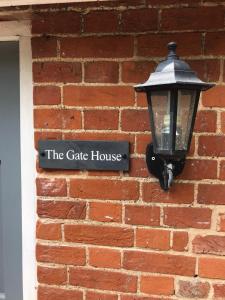 a street light on the side of a brick building at The Gatehouse in Long Melford