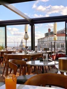 a restaurant with tables and chairs and a view of the city at RUZ Hotels in Istanbul