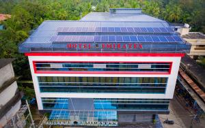 a hotel with solar panels on top of a building at Hotel Emirates in Kānnangād +16 photos