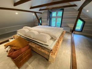 a bedroom with a large bed on a wooden frame at Byskolan Norra Skärvången in Föllinge