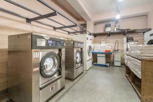 a laundry room with two washing machines in it at Summit Alpine Abode Hotel Centrally Air Conditioned in Gangtok