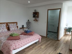 a bedroom with a bed and a table and a door at Les Muches in Bouzincourt