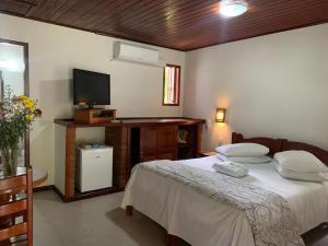 Cama ou camas em um quarto em Pousada Caminho das Candeias