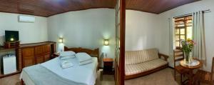 Cama ou camas em um quarto em Pousada Caminho das Candeias