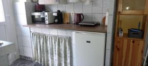 a kitchen with a counter top with a microwave at Ov152 Apartman in Budapest