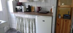 a kitchen with a counter top with a microwave at Ov152 Apartman in Budapest +10 photos