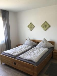 a bed in a bedroom with two pillows on it at Ferienwohnung-Bayrisch-Nizza in Sulzbach am Main