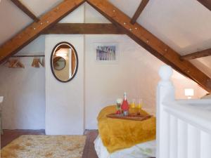 a room with a round bed in a attic at Y Stabl - Uk35032 in Carmarthen