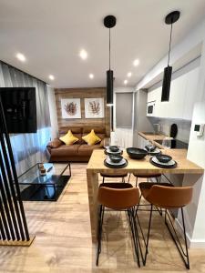 a kitchen and living room with a table and chairs at Silver & Brownie, Nuevo apart cerca de la Playa in Playa de las Americas
