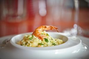 a plate of food with a shrimp on risotto at PortoBay Falesia in Albufeira