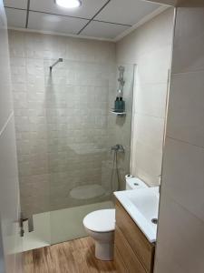 a bathroom with a shower and a toilet and a sink at Agradable casa familiar en Pliego. in Pliego