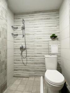 a bathroom with a toilet and a shower at Fenix 2 Bedroom Apartment Varna Center in Varna City