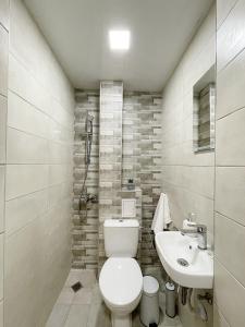 a bathroom with a toilet and a sink at Fenix 2 Bedroom Apartment Varna Center in Varna City