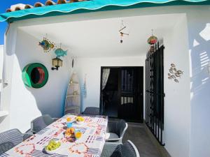 a dining room with a table and chairs at Beach Bungalow Holiday Home in Adeje