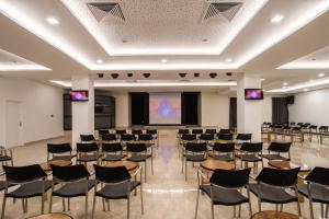 a large room with chairs and a projection screen at Dar Khayam in Hammamet