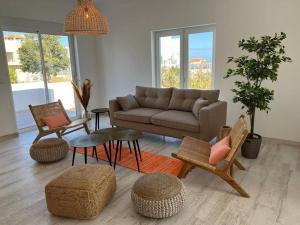 ein Wohnzimmer mit einem Sofa und Stühlen in der Unterkunft Casa Chlodette - luxury villa, 5 bedroom, private pool in Fuseta