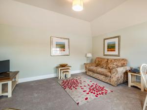 a living room with a couch and a table at The Stables - Uk36121 in Horsington