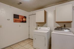 a kitchen with a stove and a washer at RARE FIND Modern Townhome in the Heart of Old Colorado City in Colorado Springs