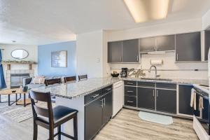 a kitchen with a counter and a dining room at RARE FIND Modern Townhome in the Heart of Old Colorado City in Colorado Springs