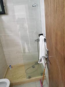 a bathroom with a glass shower with a toilet at mehdiya plage in Kenitra