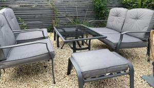 a group of chairs and a table and a coffee table at Beachcomber Cottage in Troon