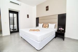 a large white bedroom with a large white bed at Dunia Hotel Bamako in Bamako