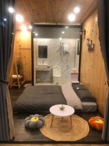 a room with a bed and a sink and a table at Nhà Bắp in Da Lat
