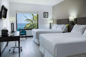 Letto o letti in una camera di NH Iquique Costa