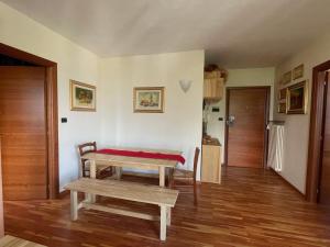 a living room with a table and a bench at The Panoramico in Sauze dʼOulx +5 photos