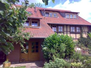 an old house with a red roof at Familienferienhof Sell´s Scheune in Sundhausen +20 photos
