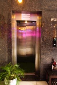 a elevator in a building with a sign on it at The कस्तूरी in Maihar