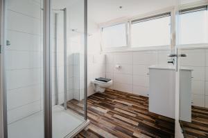 a bathroom with a shower and a toilet at Appartementen Renesse in Renesse