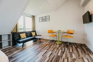 a living room with a couch and a table at Appartementen Renesse in Renesse