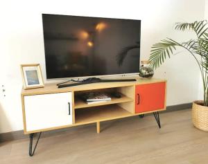 a entertainment center with a large television on top of it at CHIC 2CHAMBRES,70m²+balcon+parking+WIFI in Nantes