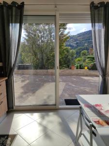 a sliding glass door with a view of a patio at L'Ambre d'Or in Falicon