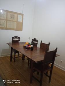 a wooden dining room table with four chairs and a table at Happy at Chiado in Lisbon