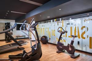 une salle de sport avec des appareils de cardio-training et un mur avec des numéros. dans l'établissement CAMPANILE PARIS 12 - Bercy Village, à Paris