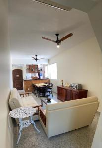 a living room with a couch and a table at Apartamento - CARIBE BRASILEIRO - Praia do Forte - De frente para o mar in Cabo Frio