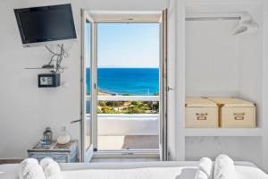 a bedroom with a bed and a view of the ocean at Studio with Seaview at Faragas in Angairiá