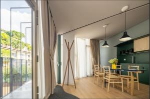 a dining room and kitchen with a table and chairs at Heart Milan Apartments Porta Romana in Milan