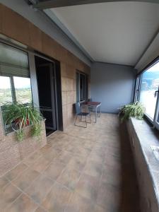 an empty room with a patio with a table and windows at Apartment House - Delta in Sofia