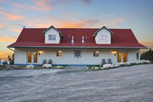 a house with a red roof on a dirt road at Ranchette Eagles Roost - The Atsa #9 at Wind Walker Homestead in Spring City